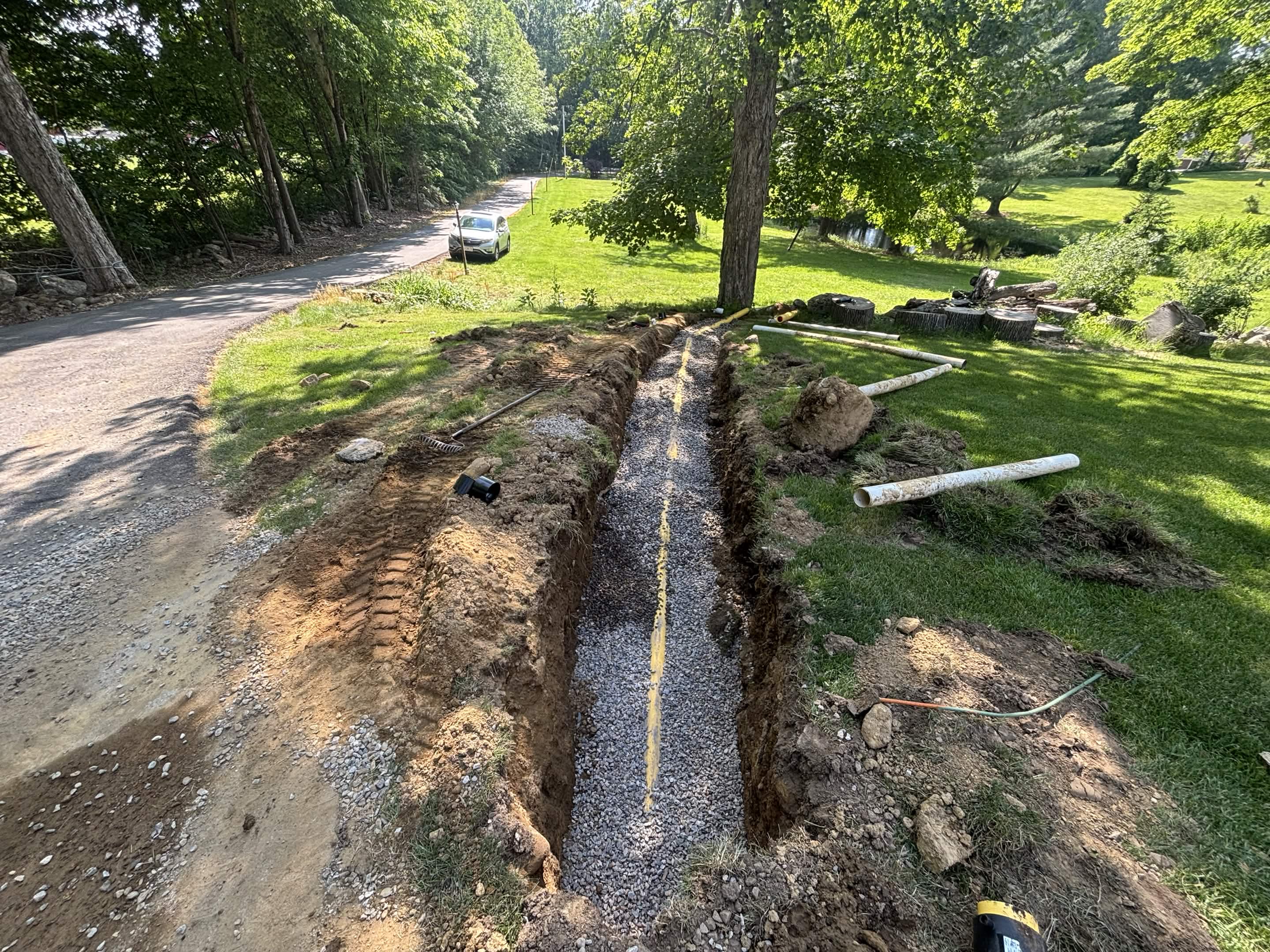 Collector pipe installed in trench running to pond
